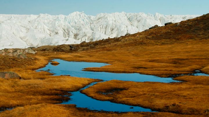 Snowy mountain behind moorland and lakes