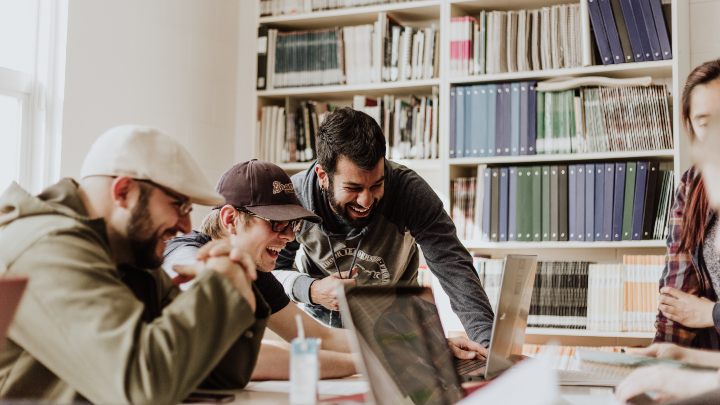 Group of students around a laptop