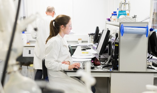 Female cancer scientist working in lab at The University of Manchester