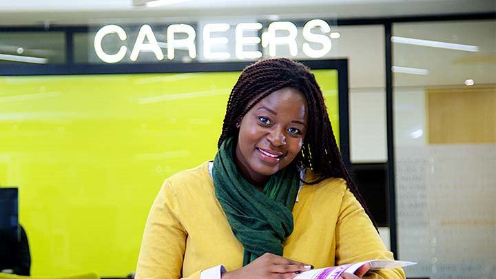 Careers adviser smiling at her desk