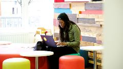 A female student sat at a laptop.