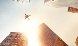 Plane flying over buildings