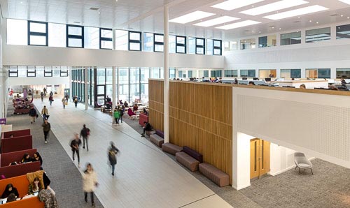 A bustle of people studying and working within the University’s AMBS building. 