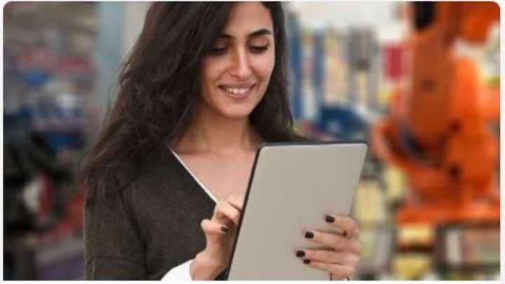 Female student on a hand held tablet.